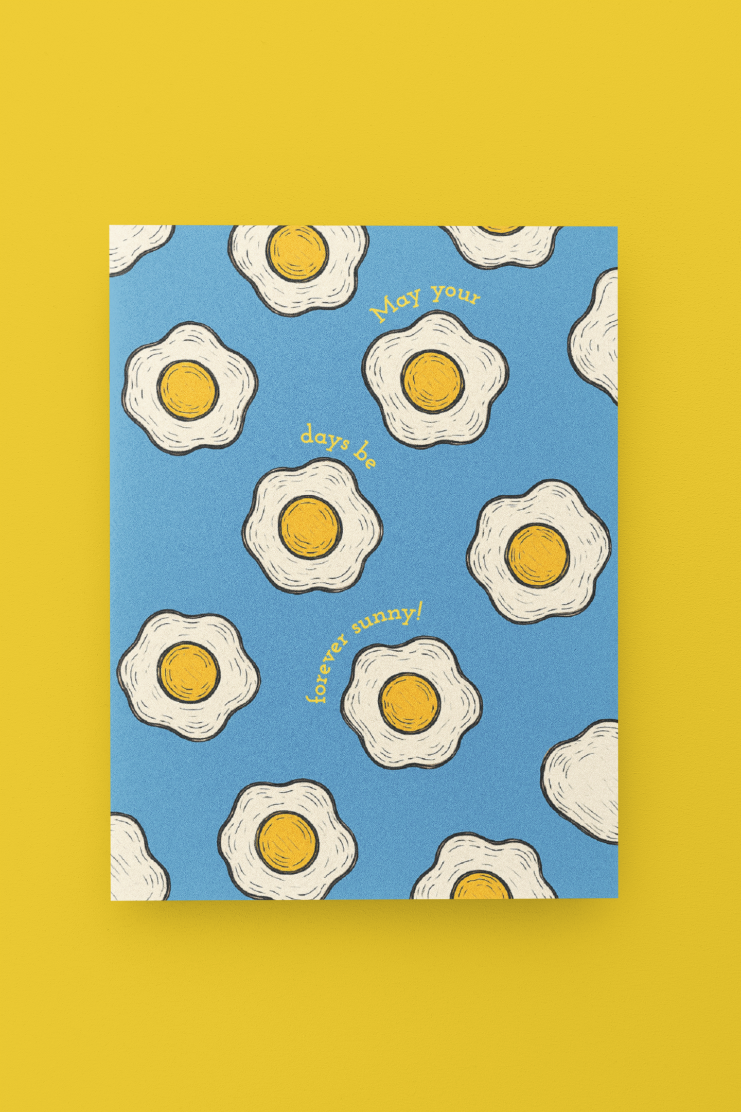  fried egg design on a blue background, featuring text, on a yellow background.