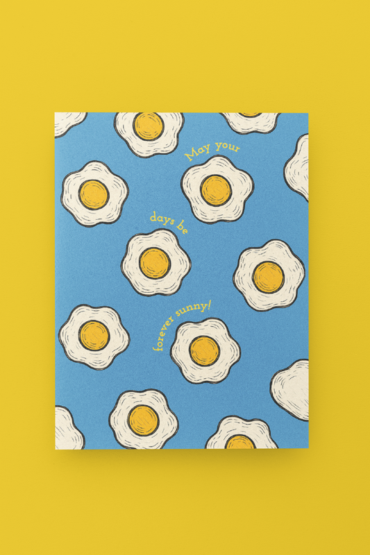  fried egg design on a blue background, featuring text, on a yellow background.