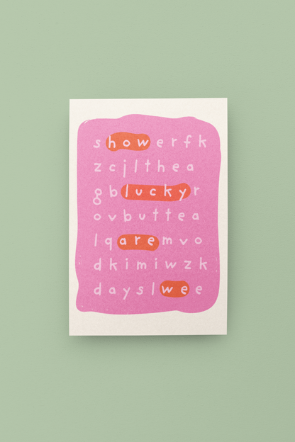 Pink card with scrambled text on a green background