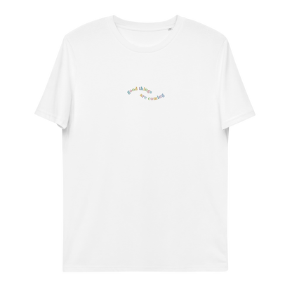 A white t-shirt with the words 'good things are coming' embroidered  on it.